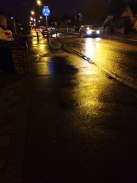 Illuminated road against sky at night