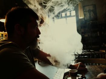 Side view portrait of man smoking