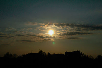 Silhouette trees against sky during sunset