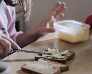 Midsection of woman preparing food on table