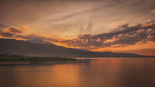 Scenic view of lake against sky during sunset