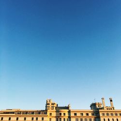 Low angle view of buildings against clear blue sky