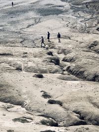 High angle view of people walking on snow land