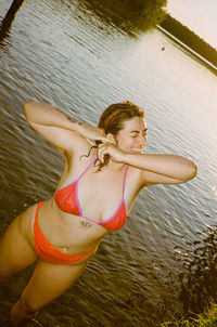 Young woman swimming in lake