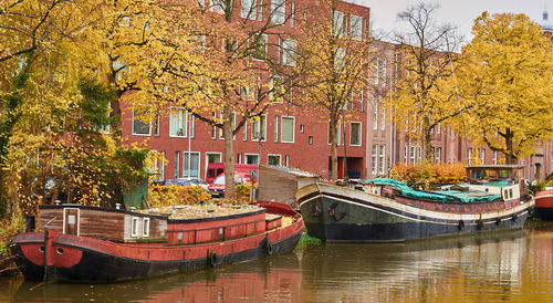 Boats moored in canal during autumn