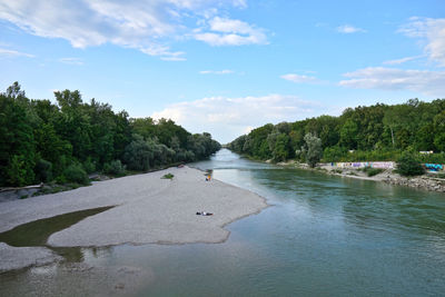 Scenic view of river amidst trees against sky