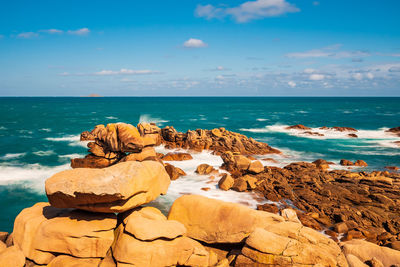 Rocks on beach against sky