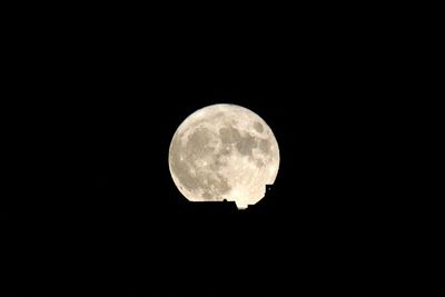 Low angle view of moon against clear sky at night