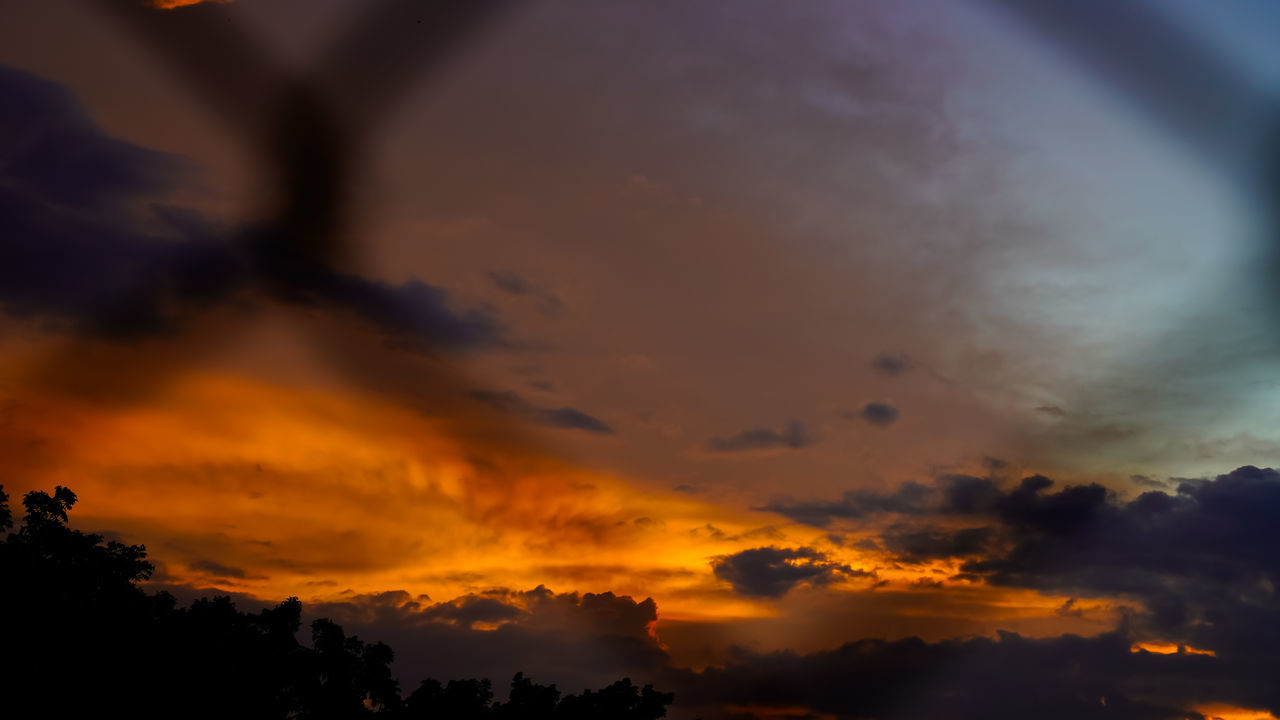 sky, cloud, sunset, beauty in nature, dramatic sky, scenics - nature, nature, environment, tranquility, silhouette, orange color, no people, tranquil scene, cloudscape, sunlight, afterglow, outdoors, idyllic, evening, tree, landscape, atmospheric mood, multi colored, red sky at morning, awe, sun, dark, storm, dusk, mountain, land