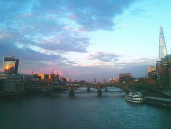 Bridge over river with buildings in background