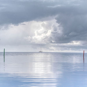 Sailboat in sea against sky