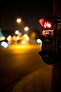 Close-up of road sign at night