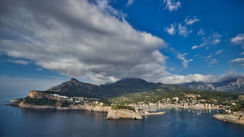 Scenic view of sea by buildings against sky