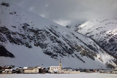 Scenic view of snow covered buildings against sky