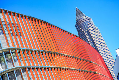 Low angle view of modern building against blue sky