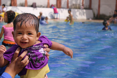 Portrait of cute boy in swimming pool