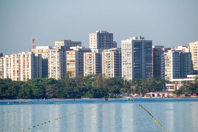 River by buildings against sky in city