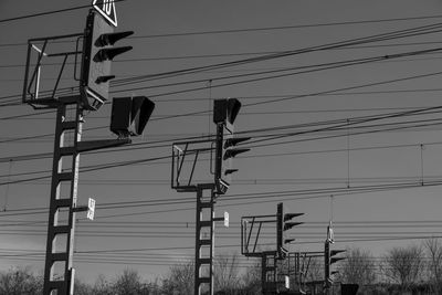 Low angle view of electricity pylon against sky