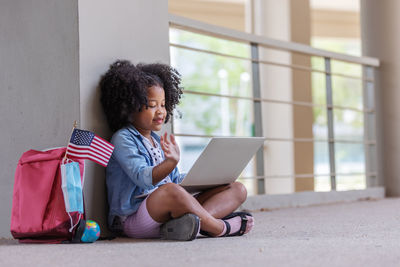 Girl using laptop in building