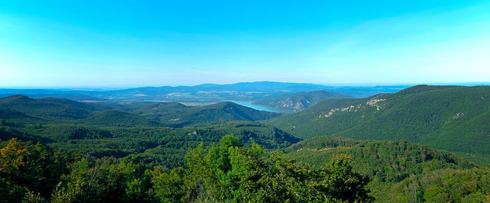 Scenic view of mountains against blue sky