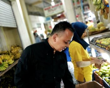 Young man looking at market stall