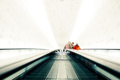 Low angle view of people on escalator