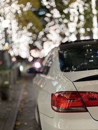 Close-up of illuminated car on road in city