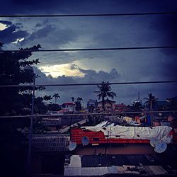 Electricity pylon against cloudy sky