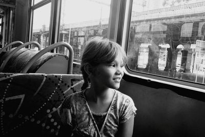 Girl looking away while traveling in bus