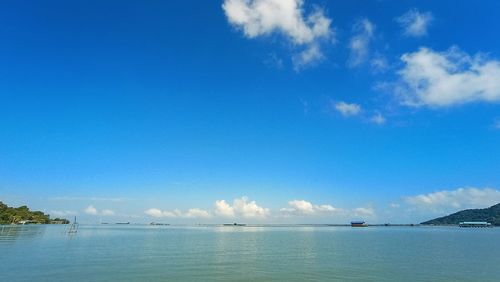 Scenic view of sea against blue sky