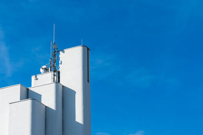 White super modern building with satellite antenna on roof