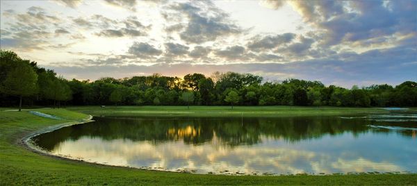 Scenic view of lake against cloudy sky