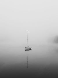 Sailboat in sea against sky