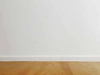 View of white wall with wooden floor