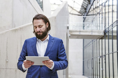 Man looking away while standing on mobile phone