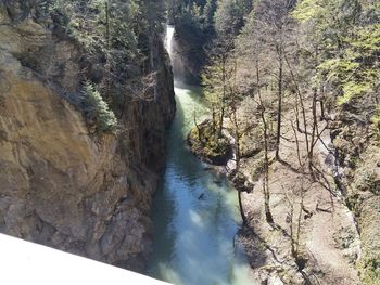 High angle view of river flowing through rocks