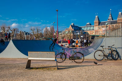 Bicycles on street against buildings in city