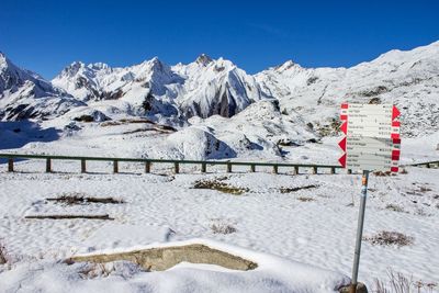 Scenic view of snowcapped mountains against clear blue sky