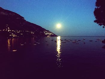 Scenic view of sea against clear sky at night