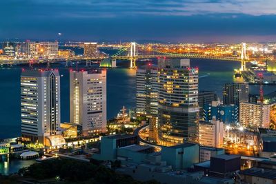 High angle view of illuminated modern buildings in city at night