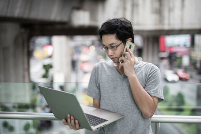 Young man using mobile phone outdoors