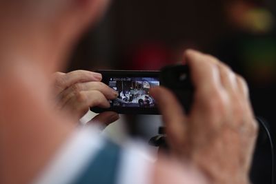 Close-up of person photographing