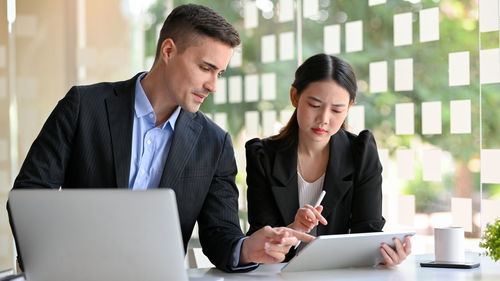 Businesswoman using laptop at office