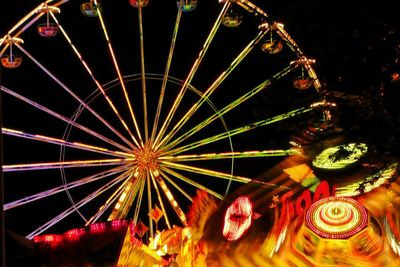 Low angle view of illuminated ferris wheel