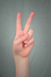 Close-up of woman hand over white background