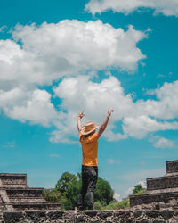 Full length of man standing of the top of a mexican pyramid