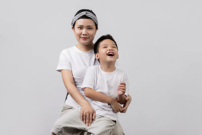 Portrait of smiling boy against white background