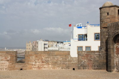Buildings against cloudy sky