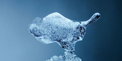 Close-up of frozen sea against blue background