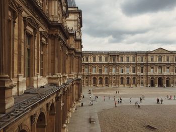 Group of people in historic building against sky